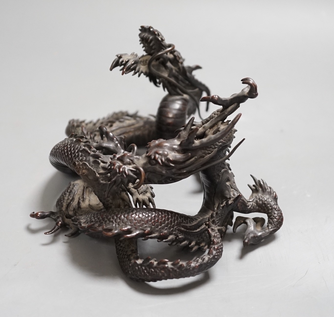 A Japanese bronze group of two entwined dragons, Meiji period, 17cms wide